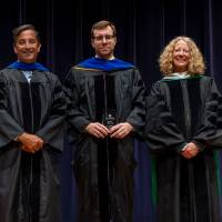 Faculty holding award with Provost and Robert Smart
